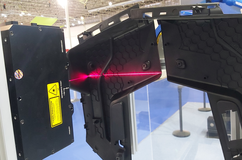 Injection-moulded plastic part being scanned for defects