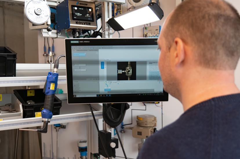 Manual assembly worker checks machine vision quality inspection system