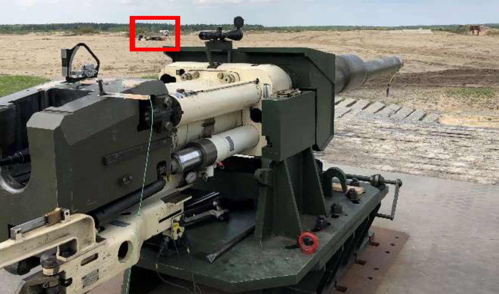 Smooth bore 120mm gun directed at a target with high-speed imaging tracker positioned in the red box out of the firing line