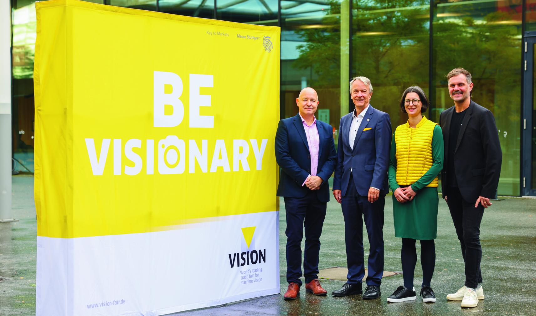 Mark Williamson, Chairman of the VDMA Machine Vision Board, Roland Bleinroth, CEO of Messe Stuttgart, Anne Wendel, Director of the VDMA Machine Vision group and Florian Niethammer, Project Manager of VISION 2026 at Messe Stuttgart, in front of VISION 2024 trade fair at Messe Stuttgart