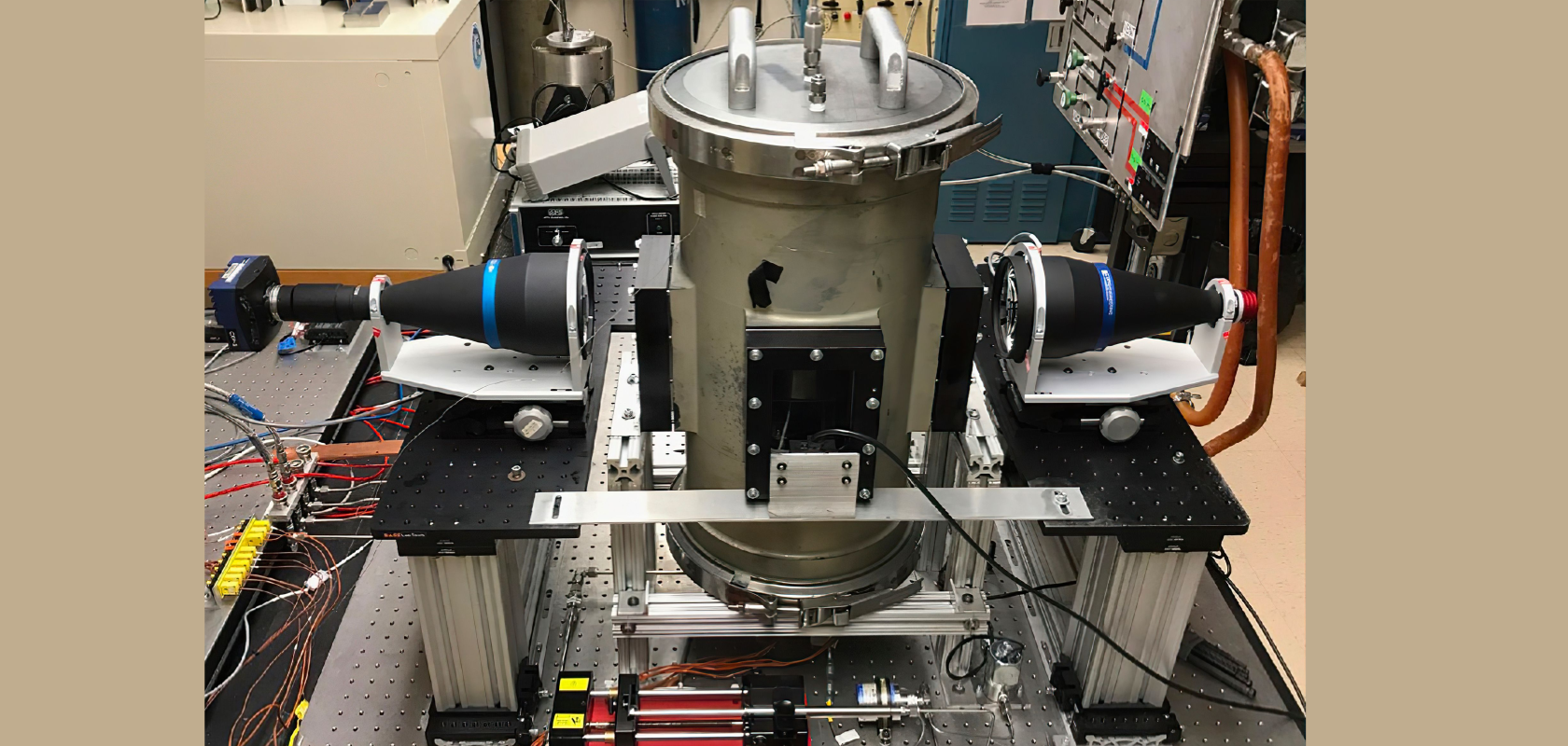 Two video cameras are positioned outside an experimental combustion chamber to capture the ignition and burning of fuel droplets (Image: NASA)