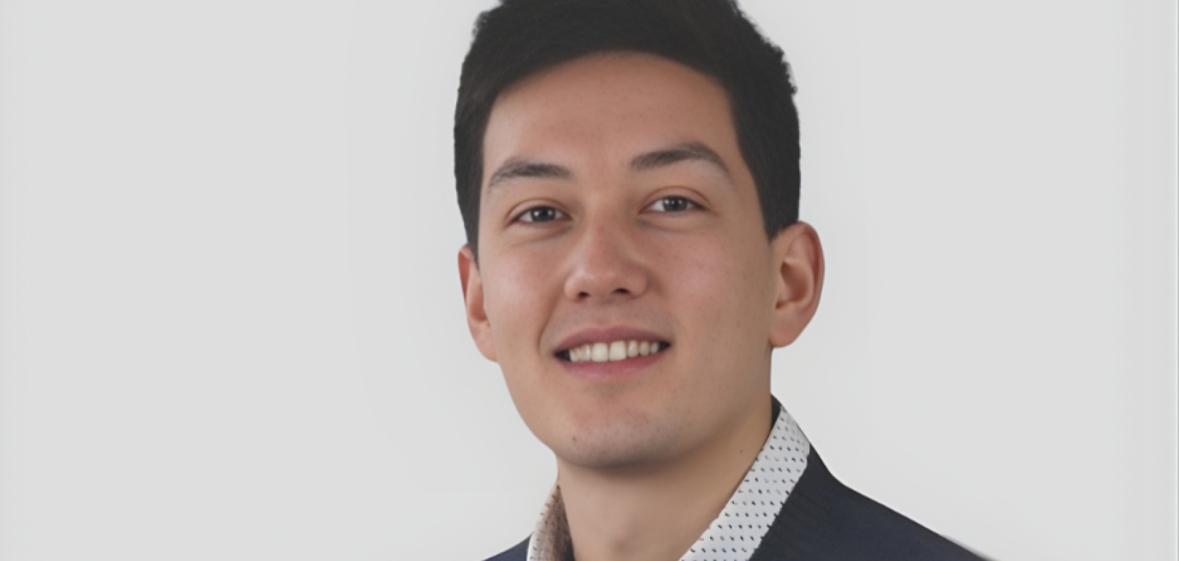 Alexandre Cottereau, Head of Product & Marketing at Effilux pictured in charcoal jacket and shirt collar against grey background. Machine vision lighting