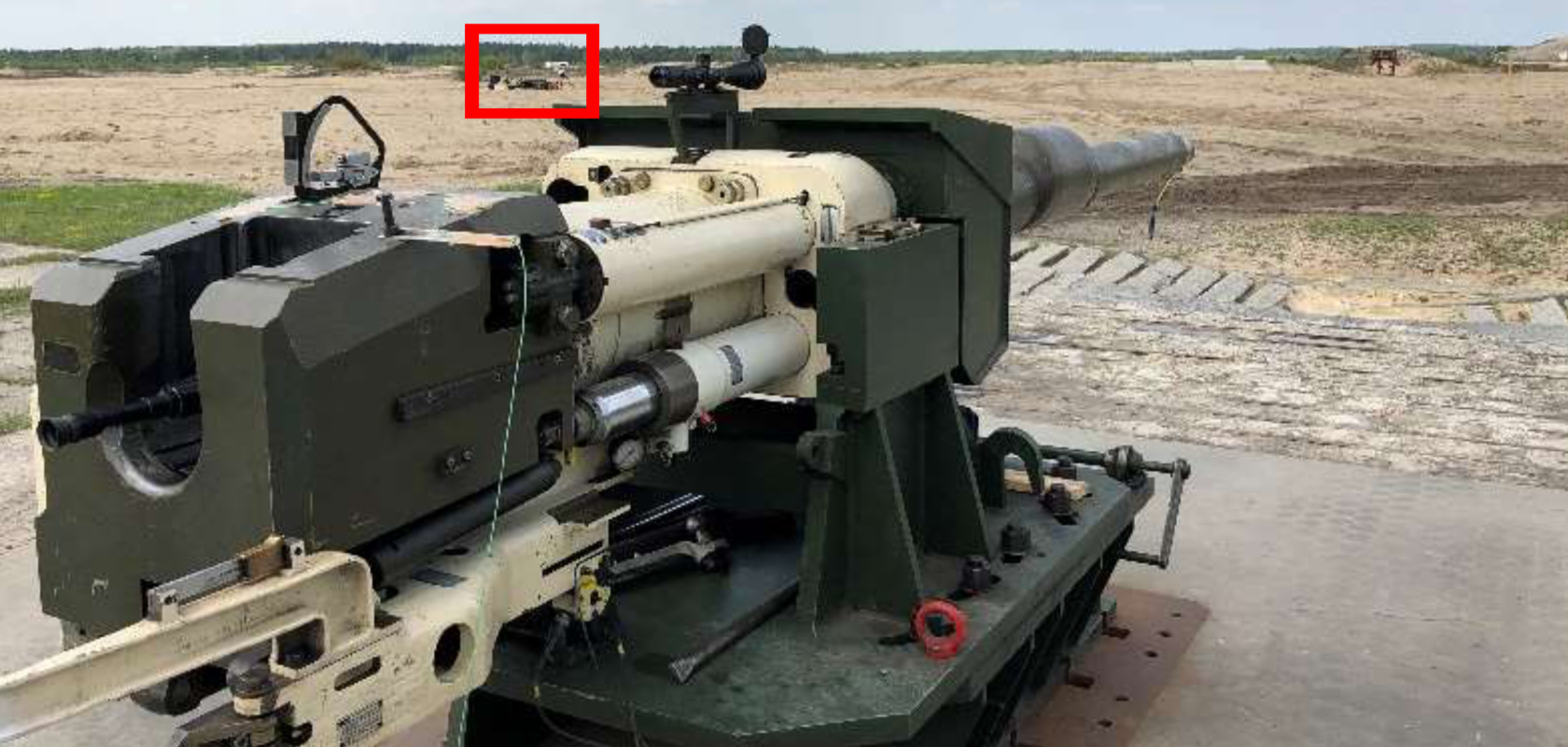 Smooth bore 120mm gun directed at a target with high-speed imaging tracker positioned in the red box out of the firing line