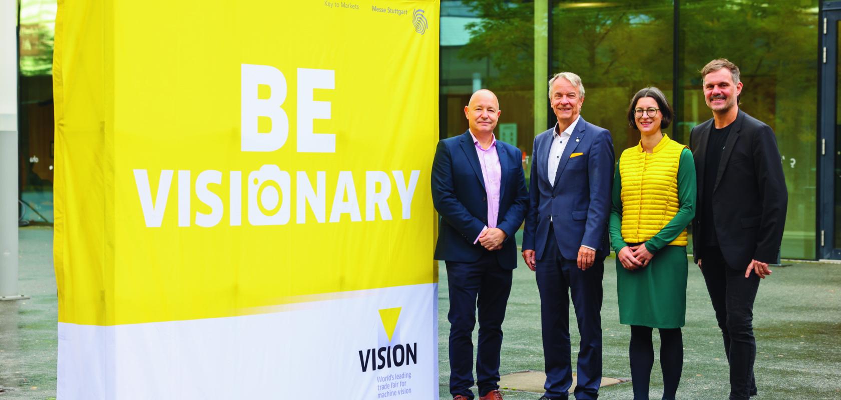 Mark Williamson, Chairman of the VDMA Machine Vision Board, Roland Bleinroth, CEO of Messe Stuttgart, Anne Wendel, Director of the VDMA Machine Vision group and Florian Niethammer, Project Manager of VISION 2026 at Messe Stuttgart, in front of VISION 2024 trade fair at Messe Stuttgart