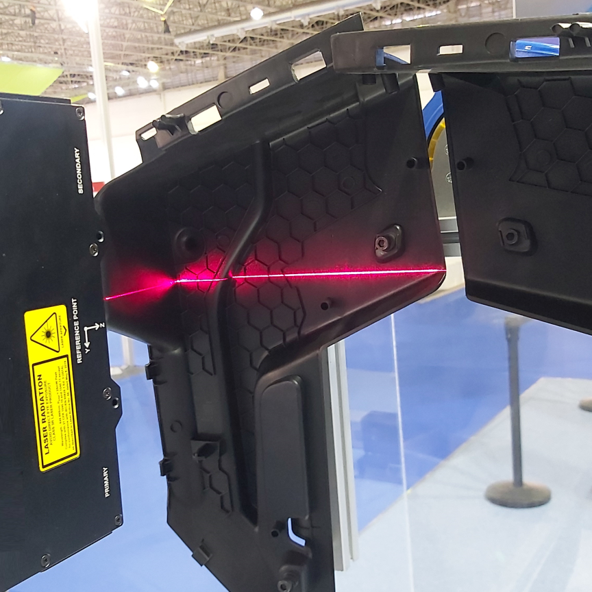 Injection-moulded plastic part being scanned for defects