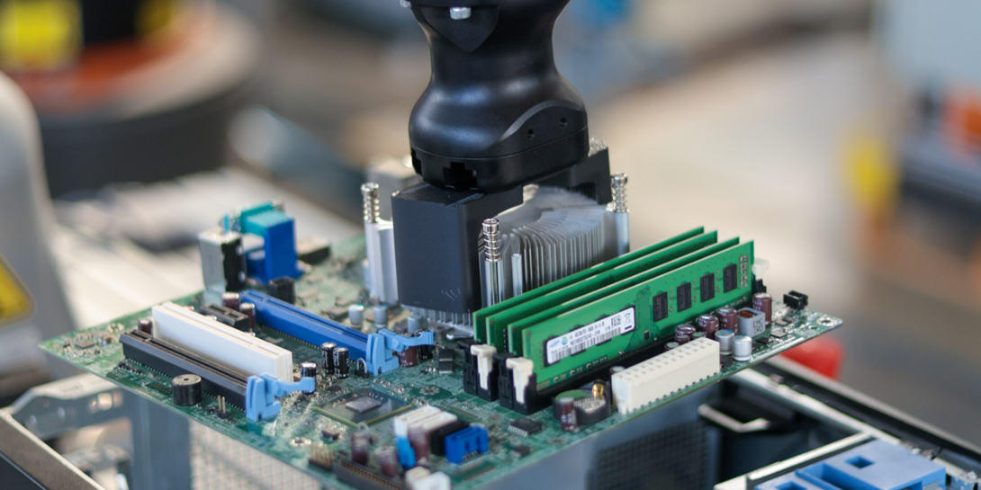 Robot lifting the motherboard out of the housing